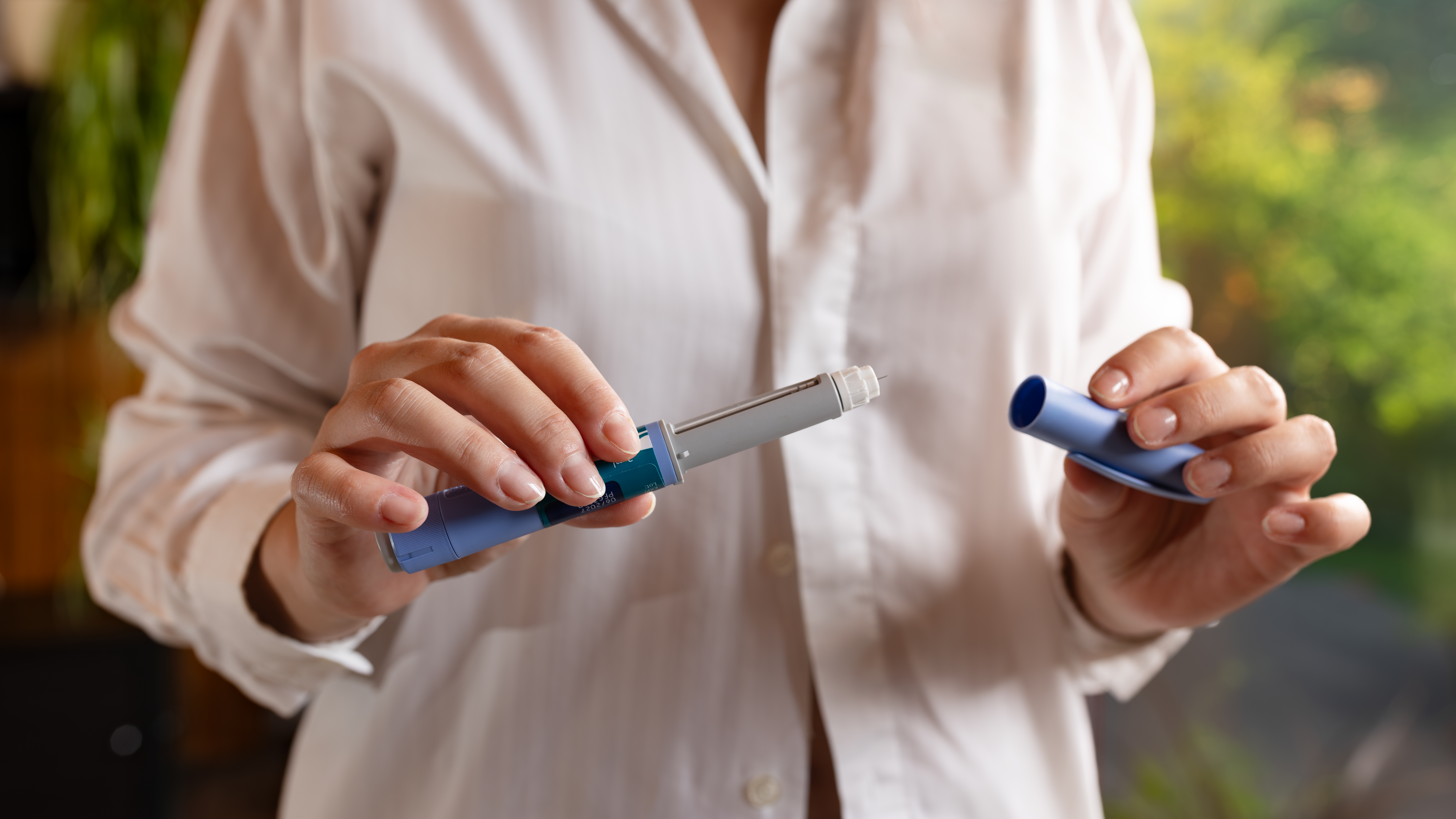 Woman using semaglutide injection pen